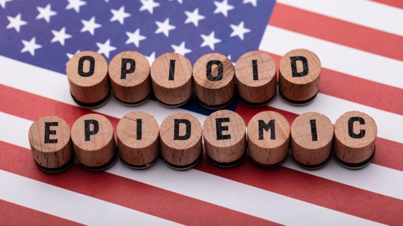 Opioid Epidemic Text On Cork Over American Flag