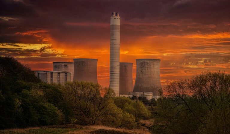 Power plant with orange sky in background