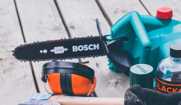 Bosch chainsaw and other work gear on a deck