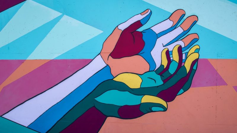 Mural of two hands holding one another