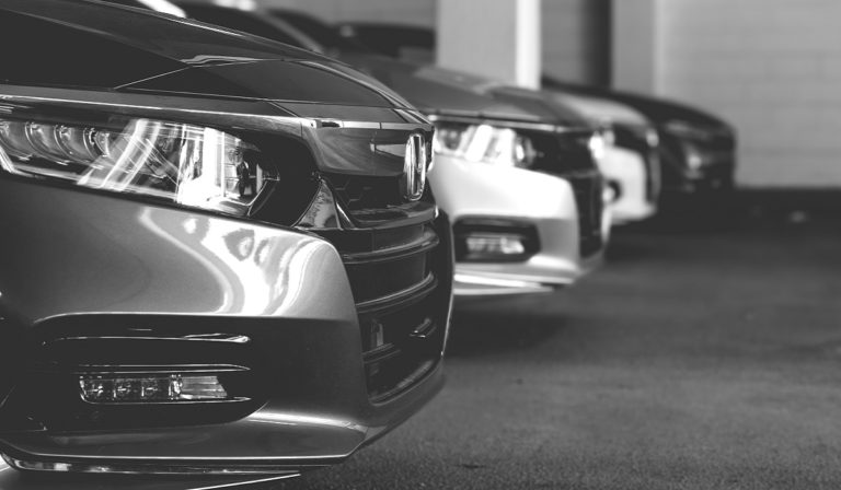 Black and white photo of a row of Honda Accords