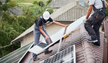 Men installing solar panels on roof