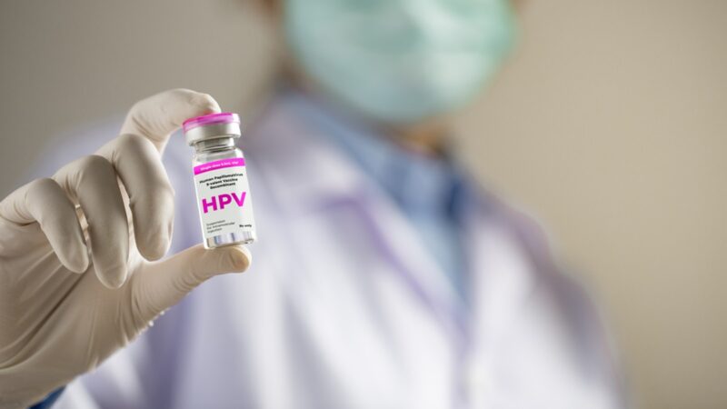 Doctor holding vial of HPV vaccine