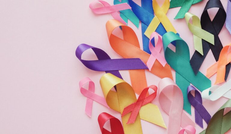 Colorful ribbons on pink background