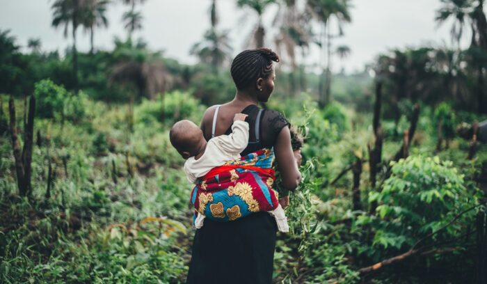 African woman carrying baby